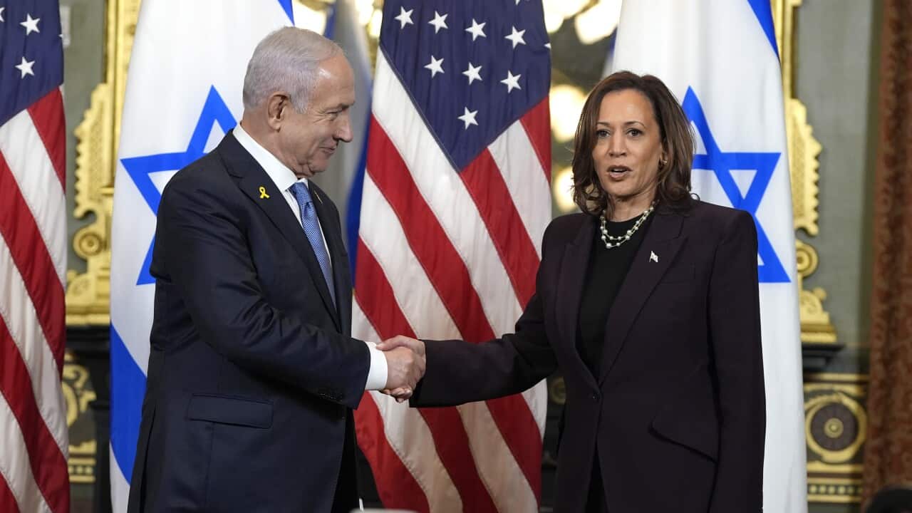 Kamala Harris shakes hands with Israeli Prime Minister Benjamin Netanyahu in front of American and Israeli flags.