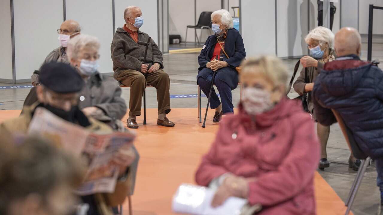 Belgium's King Albert II, rear left, and Queen Paola, rear right, sit in a waiting room after receiving their COVID-19 vaccinations at the Brussels Expo vaccine center in Brussels, Thursday, March 18, 2021. (AP Photo/Olivier Matthys, Pool)