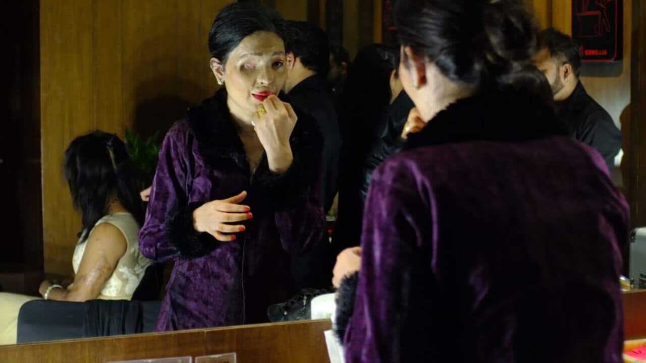 Indian acid attack survivor and model Reshma Qureshi prepares ahead of a fashion show organised by the 'Make Love Not Scars' NGO in New Delhi on November 25.