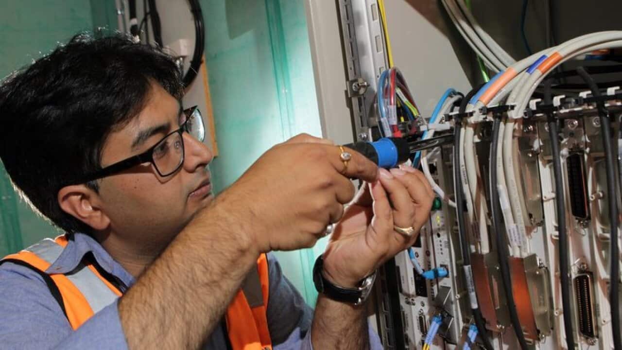 NBN technician Rajav Kapil connecting an apartment block to the National Broadband Network (NBN) in Brunswick, Melbourne, Tuesday, March 11, 2014. (AAP Image/David Crosling) NO ARCHIVING