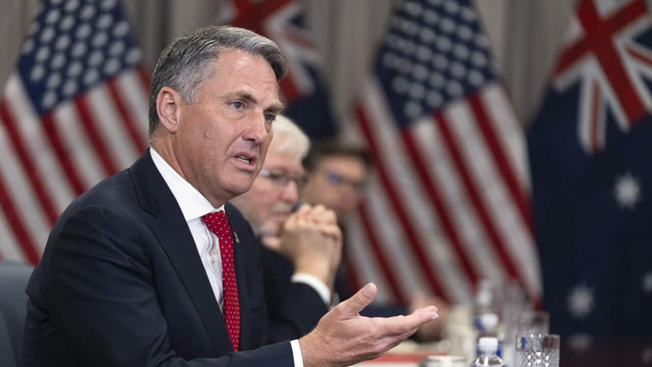 Richard Marles in a black blazer, white shirt and colourful tie.