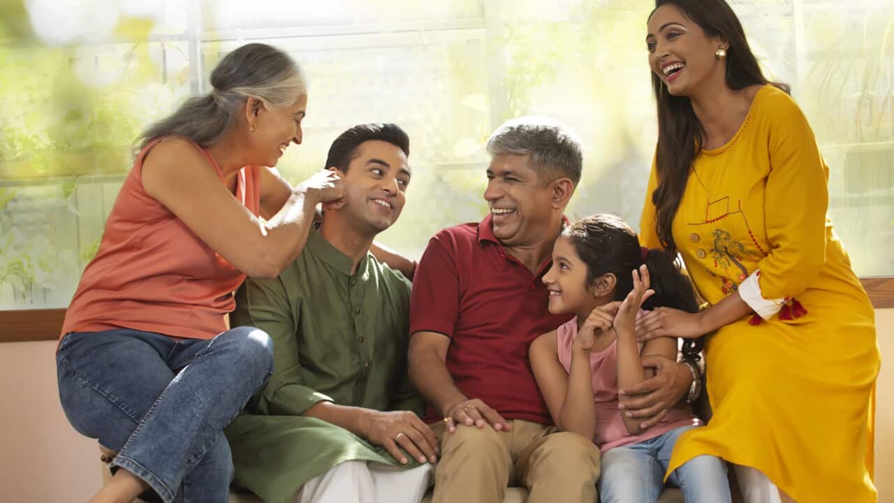 A joint family sharing a light moment