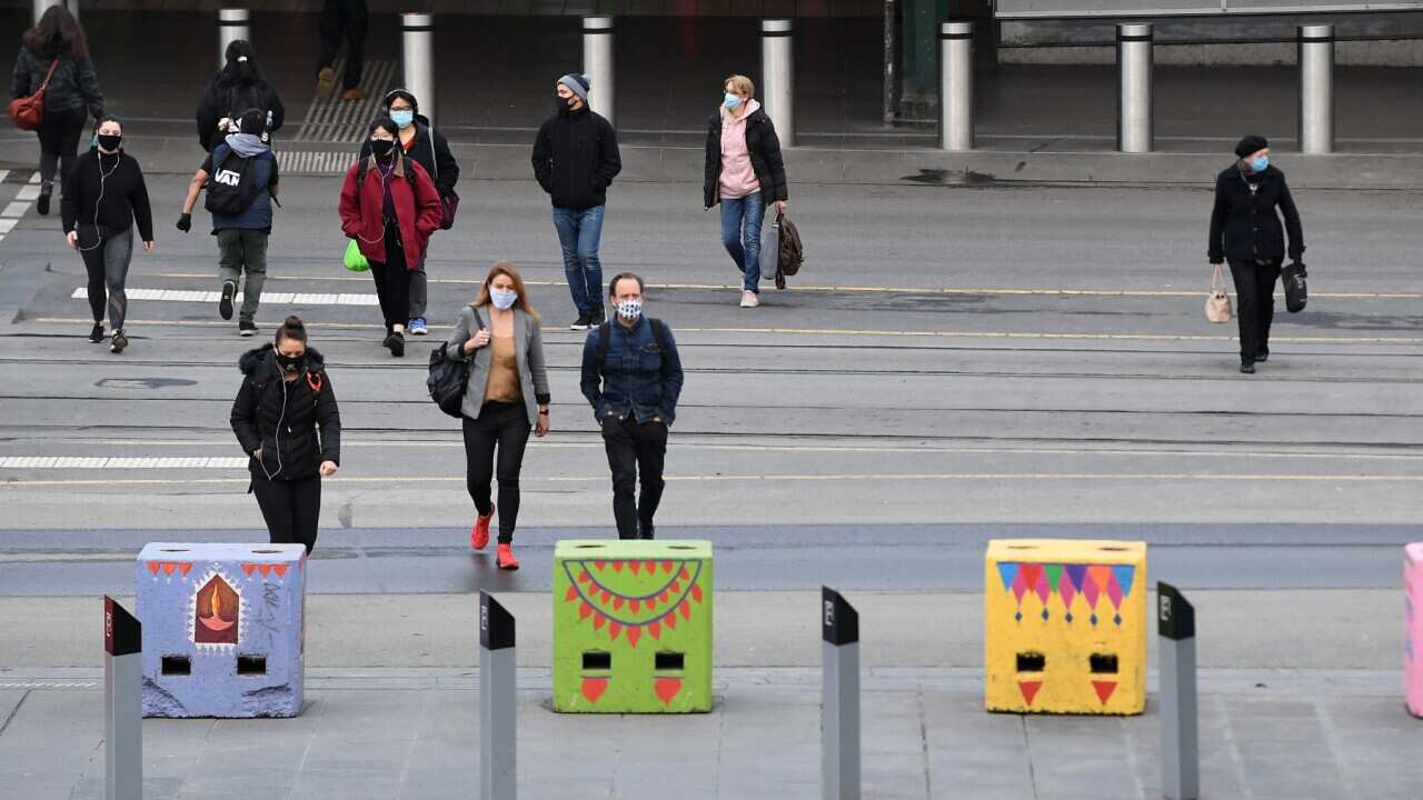 People are seen wearing face masks in Melbourne, Thursday, July 23, 2020