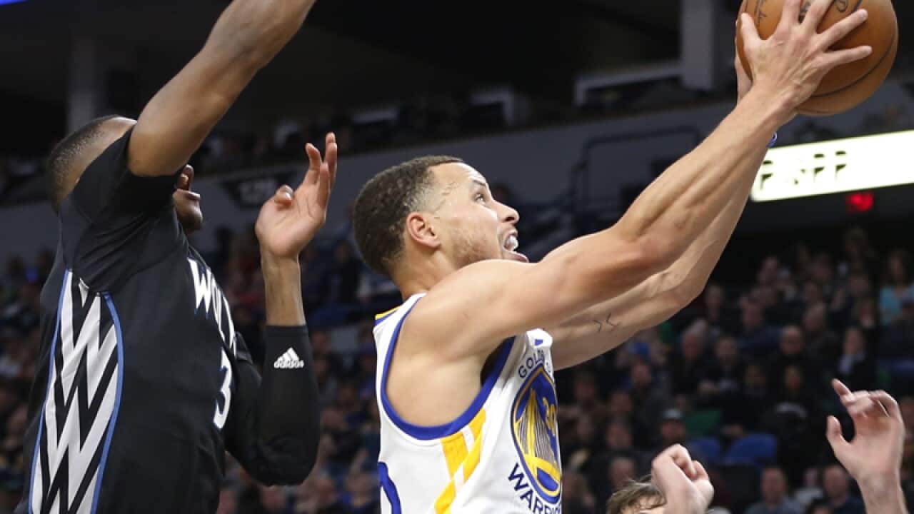 Golden State Warriors' Stephen Curry, right, lays up