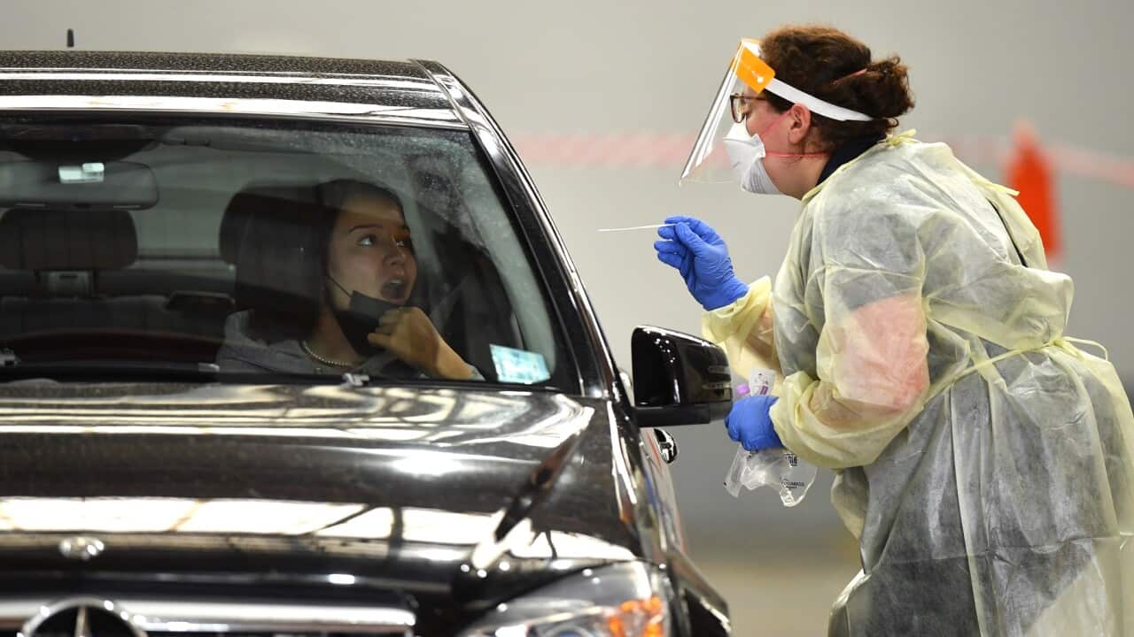 Members of the public are tested at a COVID-19 testing centre in Melbourne, Friday, March 18, 2022. No date is being given for the removal of the remaining few COVID-19 restrictions in Victoria as the state is warned to prepare for a challenging winter. (