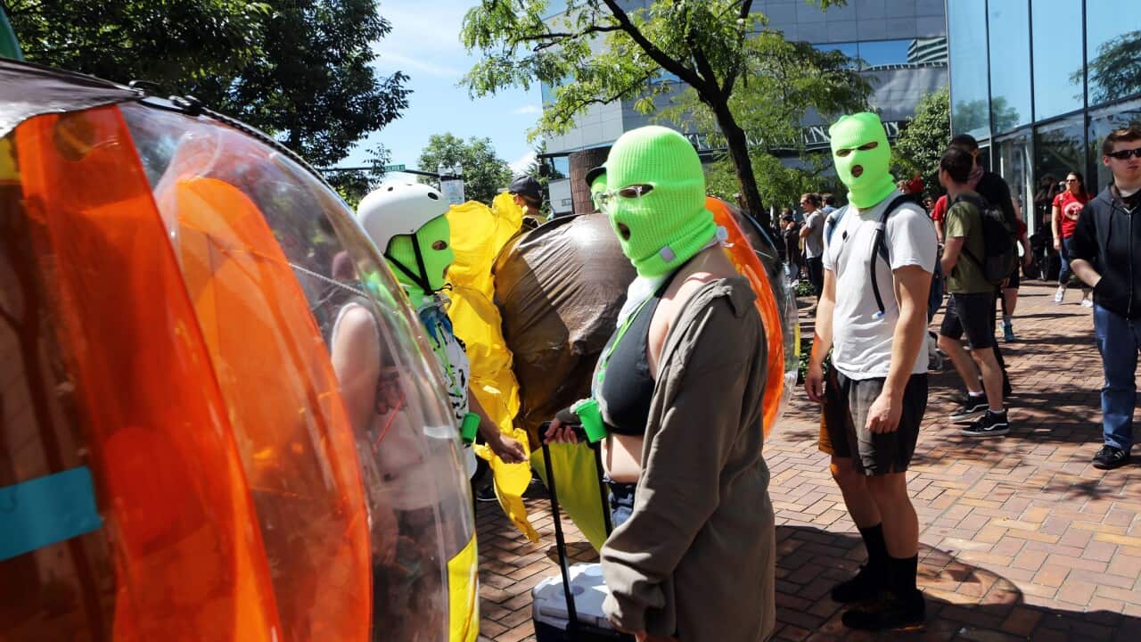 Demonstrators wearing face masks look on at a right-wing rally in Oregon, USA