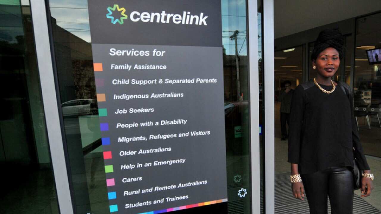 A woman leaves a Centrelink branch in Melbourne.