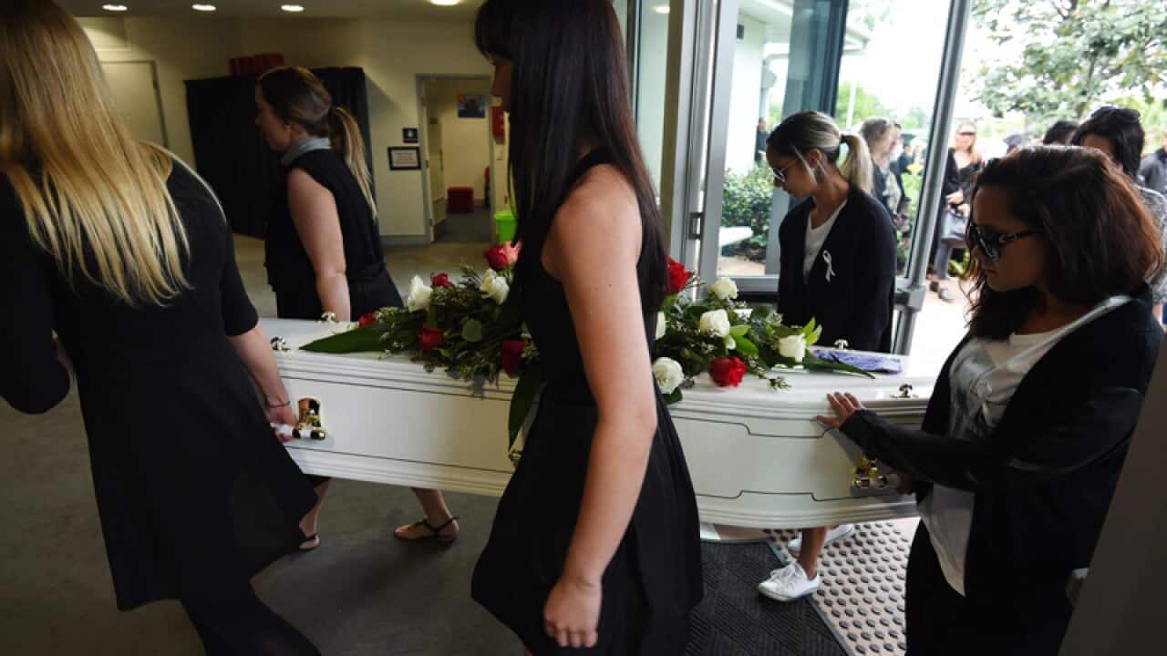 Mourners carry the coffin of Tara Brown