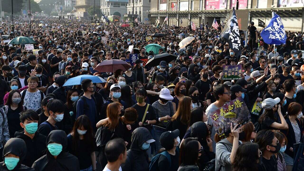People take part in a march in Hong Kong on Sunday.