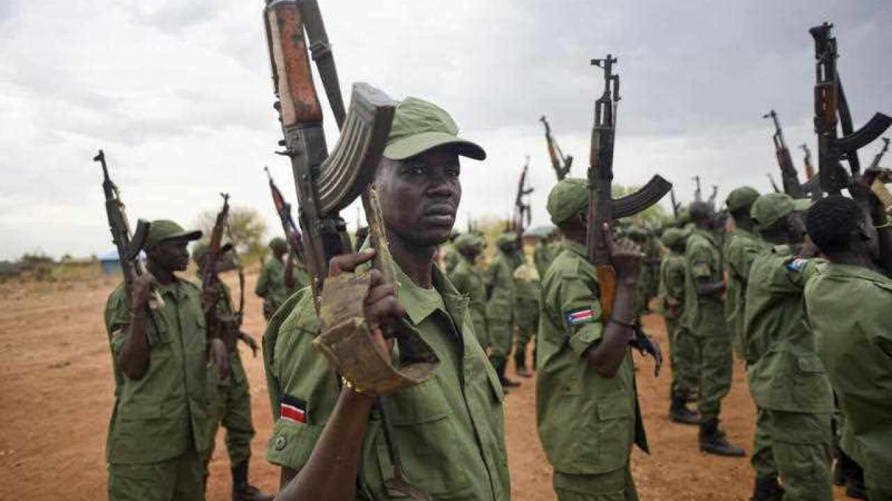 South Sudanese rebel soldiers raise their weapons at a military camp in the capital Juba, South Sudan