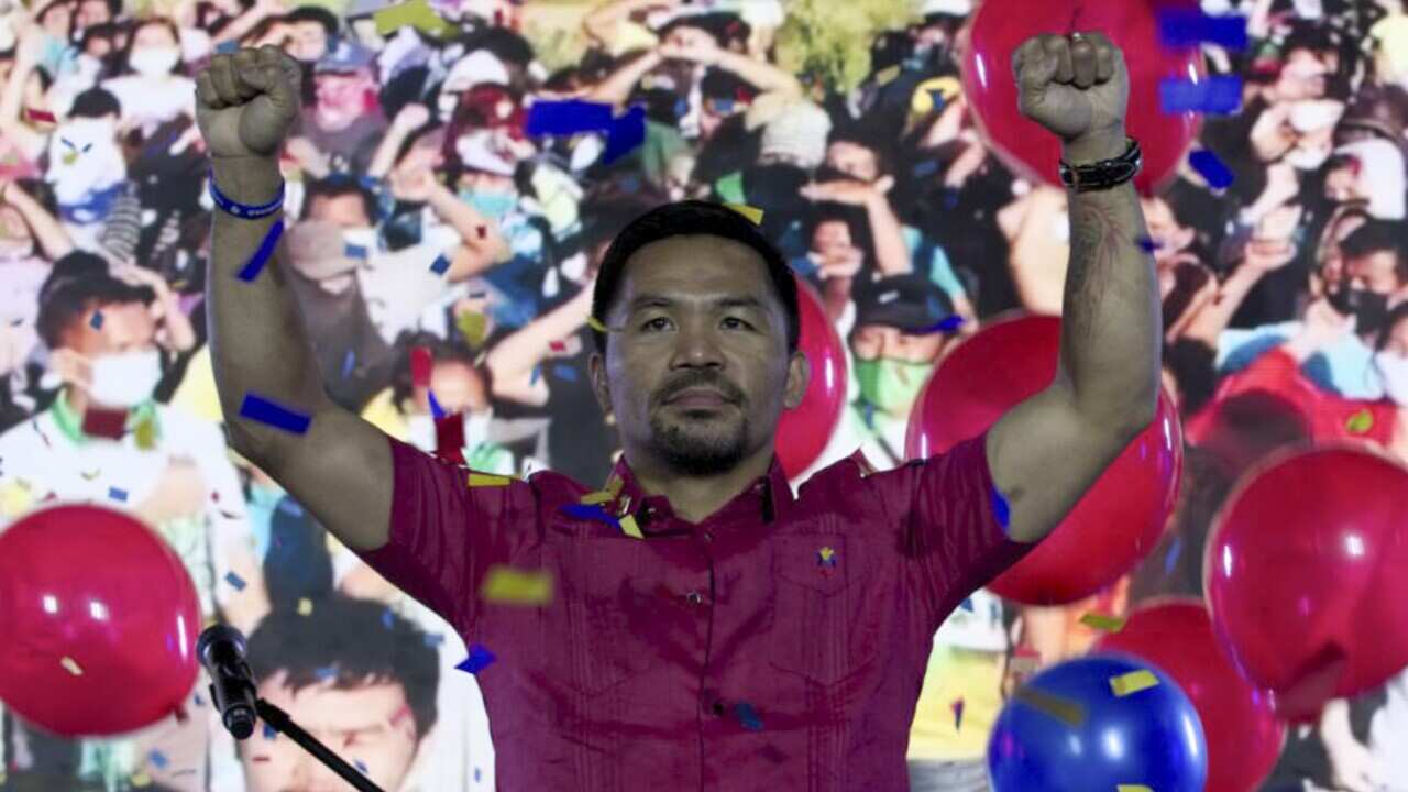 Manny Pacquiao MediaComms, Senator Manny Pacquiao raises his hands during a national convention of his PDP-Laban party in Quezon city, Philippines on Sunday.