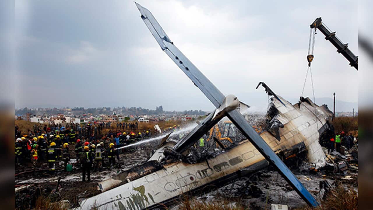 Rescue teams next to a wreckage of a plane that crashed at the main airport Tribhuvan International Airport in Kathmandu, Nepal, 12 March 2018. According to reports, Bangladeshi US-Bangla plane had crashed while landing at the airport with 71 passengers a