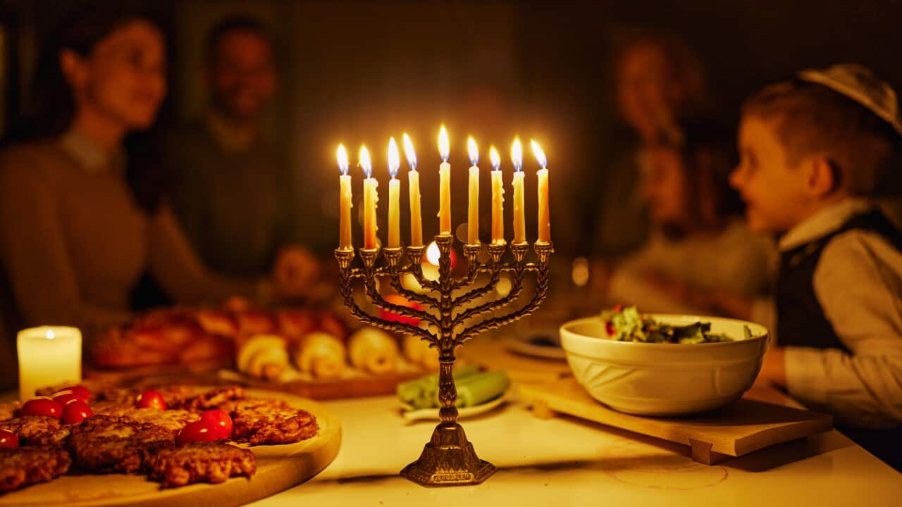 Close up of Menorah during family's dinner on Hanukkah.