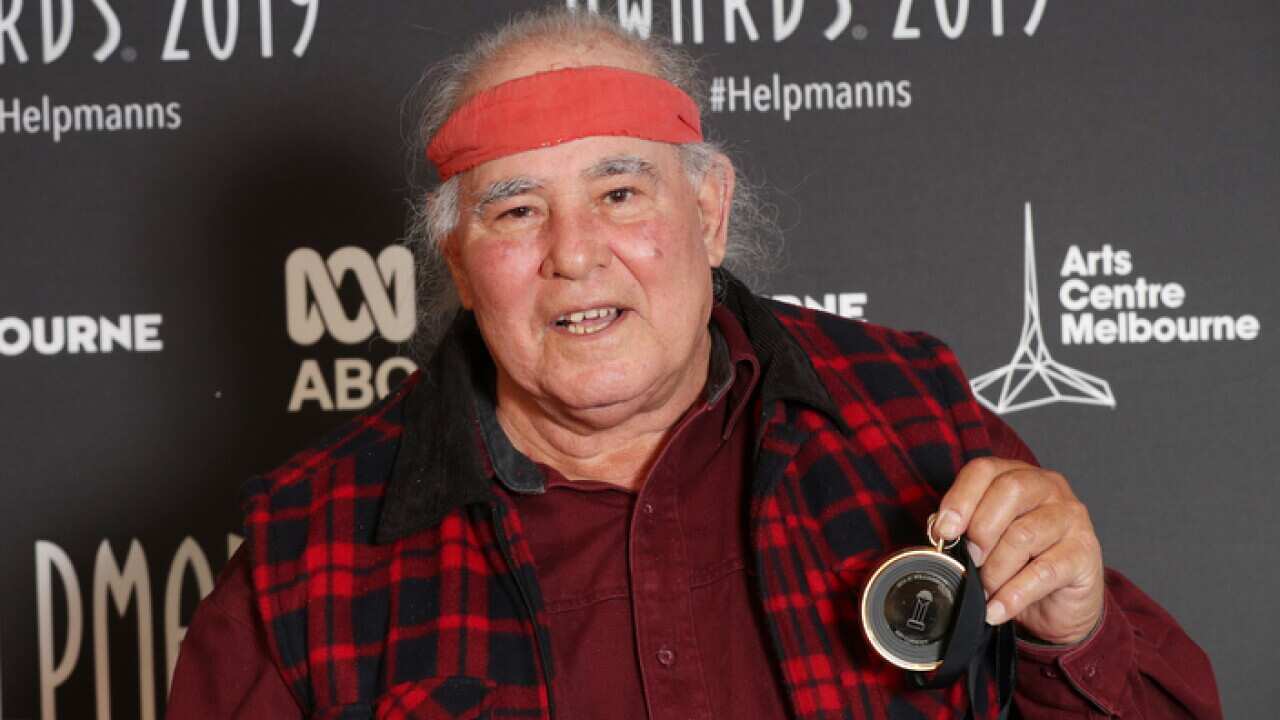 Kev Carmody poses for a photograph with the JC Williamson Award at the 19th Annual Helpmann Awards in Melbourne, Monday, July 15, 2019. (AAP Image/David Crosling) NO ARCHIVING