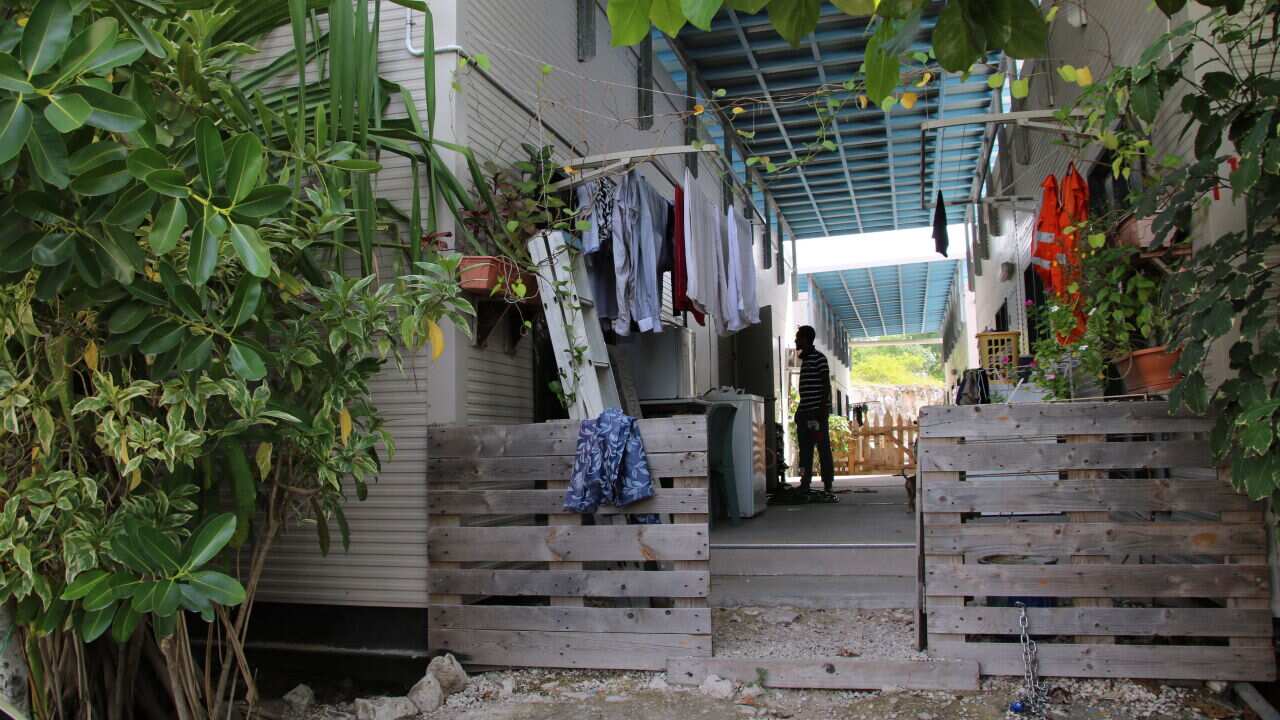 A man is seen outside a dwelling at a refugee camp on Nauru.