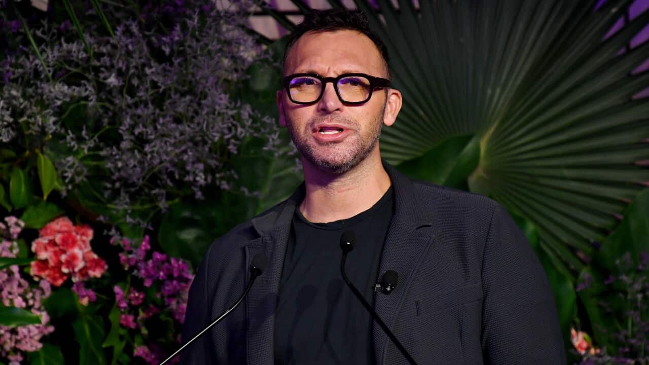 A man in a suit wearing glasses