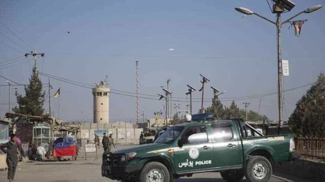 Afghanistan's National Army and police soldiers block the main road to the Bagram Airfield's main gate in Bagram, north of Kabul, Afghanistan.