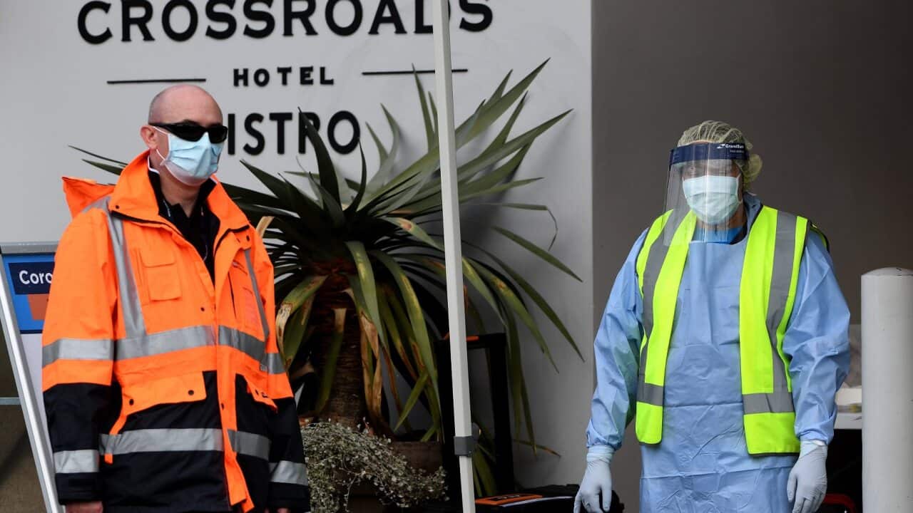 NSW Health workers and security dressed in Personal Protective Equipment are seen at the Crossroads Hotel testing centre in Sydney.