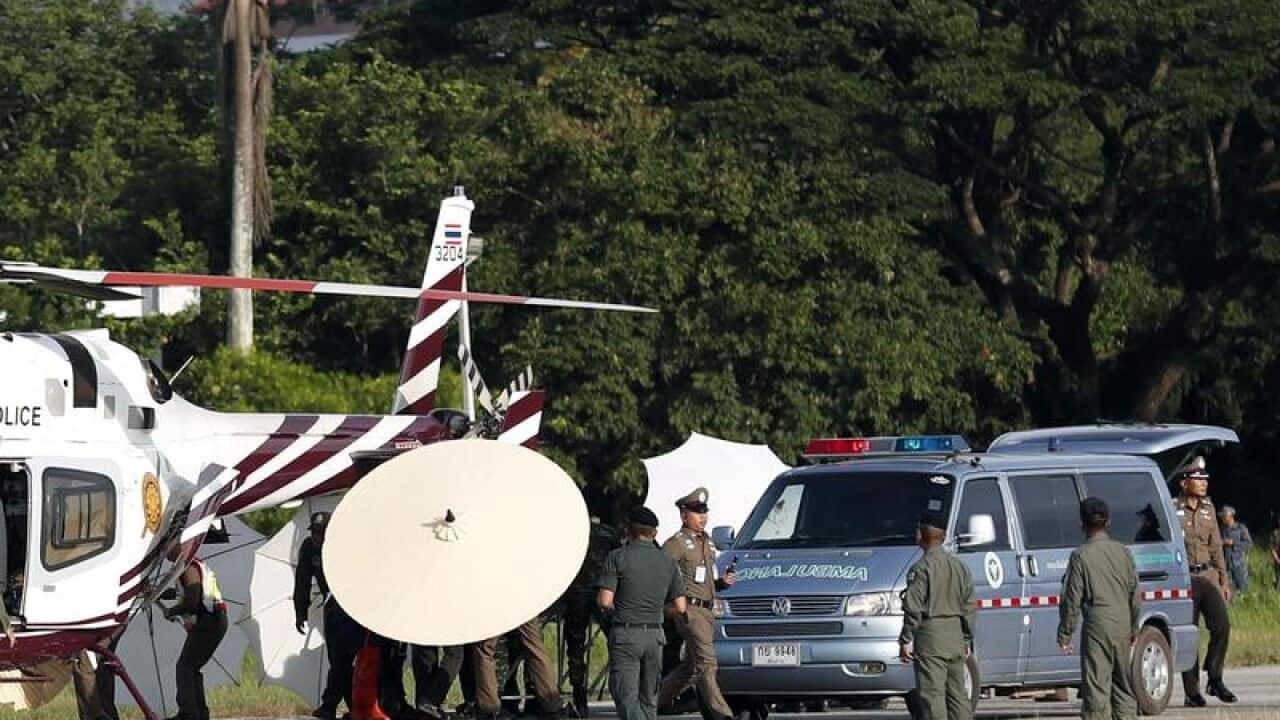 hai soldiers and police officers evacuate a boy.