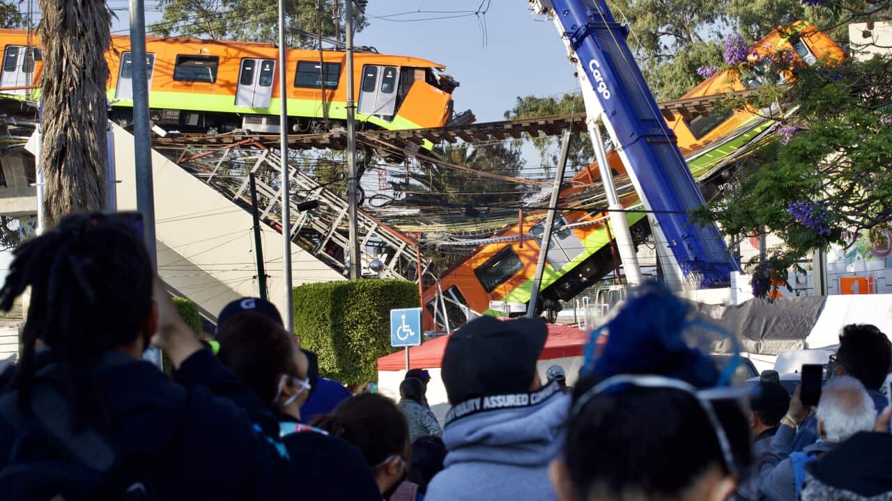 People watch on during the removal a wagon of the subway that collapsed on Monday, 3 May, 2021, in Mexico City, Mexico.