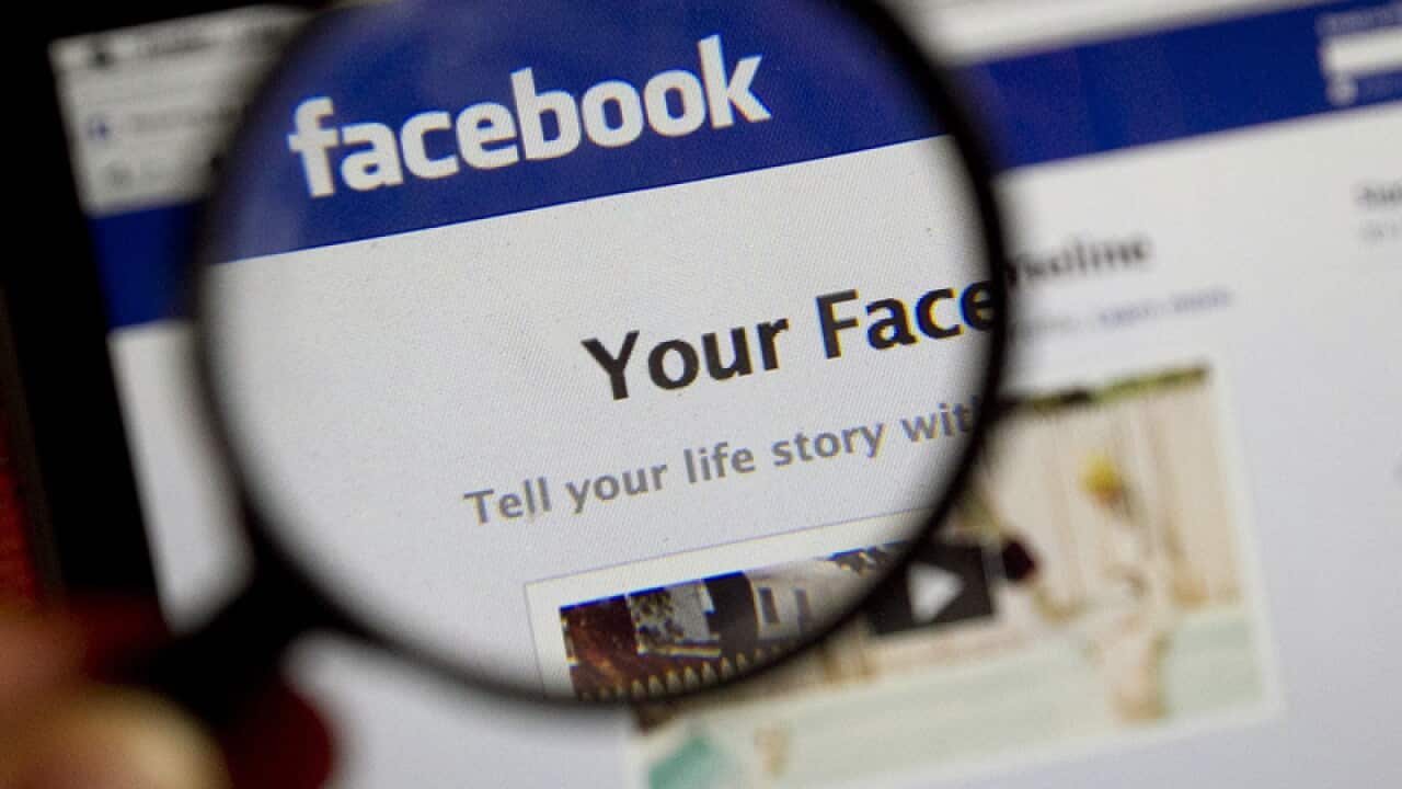 A magnifying glass shows the login screen for Facebook