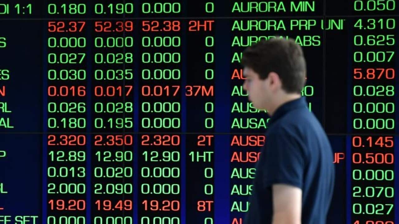 young man in from of ASX board close up
