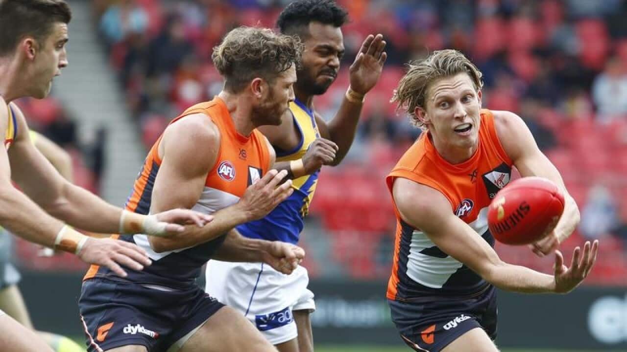 Lachie Whitfield of the Giants passes the ball during the Round 8.