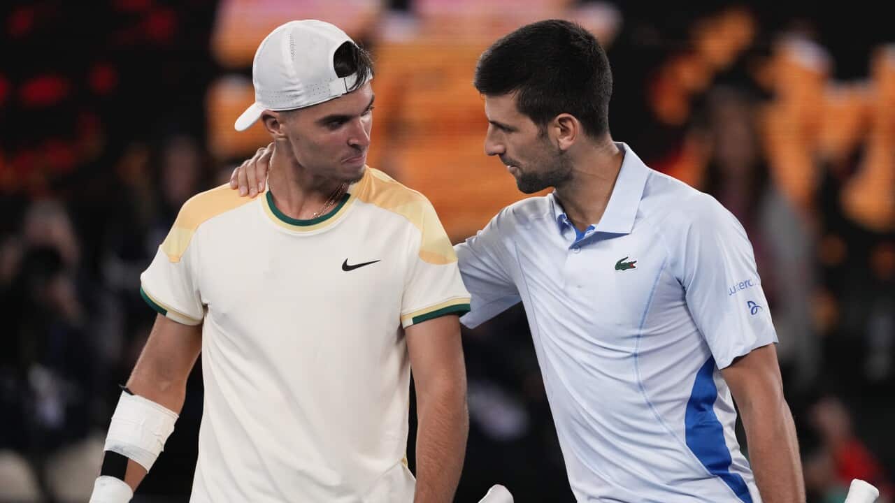 Serbia's Novak Djokovic is congratulated by Croatia's Dino Prizmic following their first round match at the Australian Open tennis championships at Melbourne Park