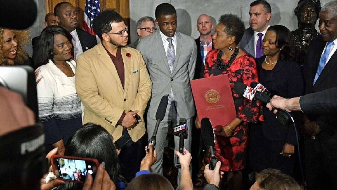 James Shaw Jr. is surrounded by family at a press conference.
