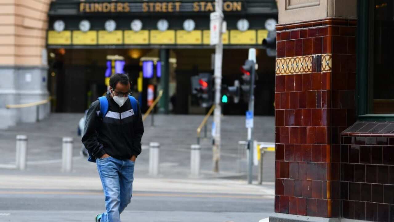 A man wearing a face mask is seen outside of Flinders Street Station in Melbourne, Thursday, August 6, 2020