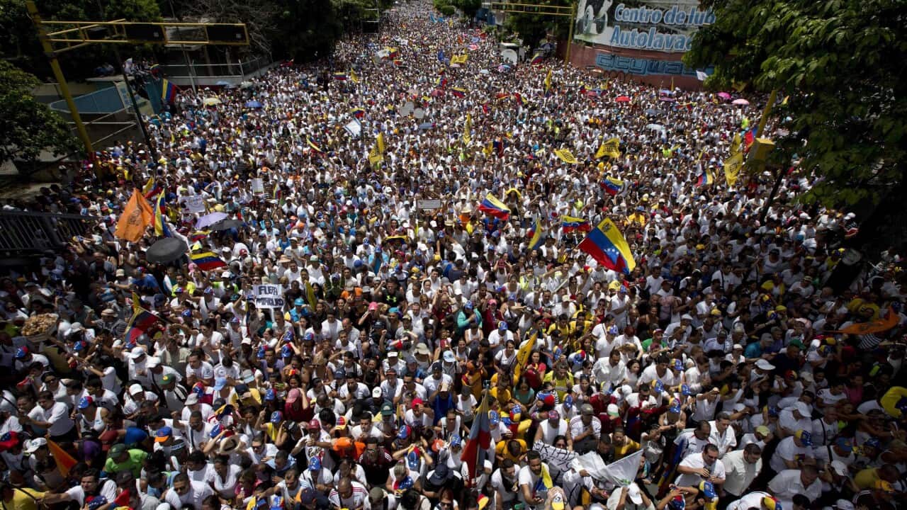 In this Sept 1, 2016 photo, demonstrators take part in the "taking of Caracas" march in Caracas.
