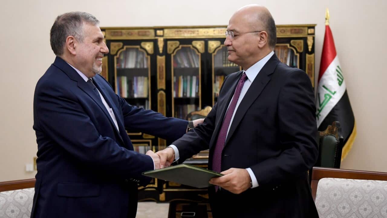 Iraq's president Barham Salih (R) assigns the country's former communications minister Mohammed Tawfiq Allawi (L) to form a new government, in Baghdad.