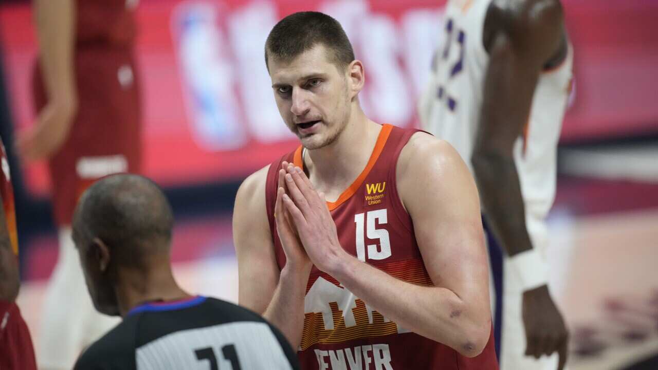 Denver Nuggets center Nikola Jokic (15) argues for a call with referee Rodney Mott (71) in the first half of Game 4 of an NBA second-round playoff series against the Phoenix Suns, Sunday, June 13, 2021, in Denver. (AP Photo/David Zalubowski)