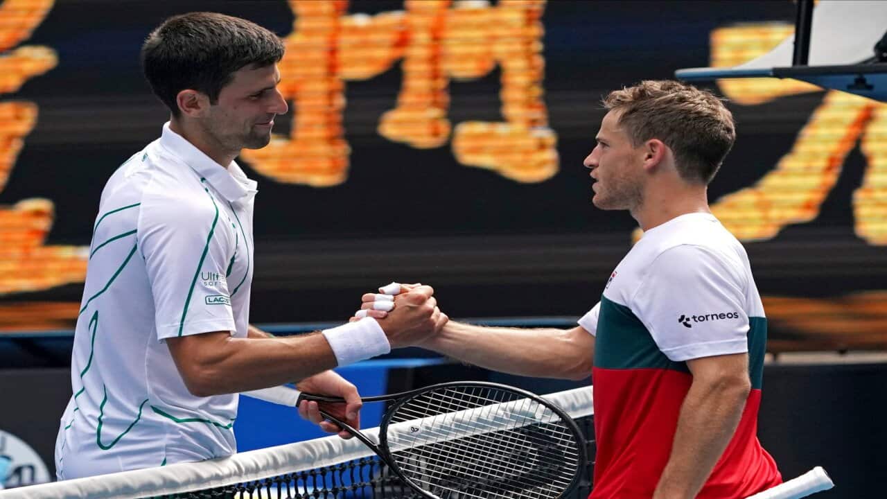Serbia's Novak Djokovic, left, is congratulated by Diego Schwartzman of Argentina after winning their fourth round singles match at the Australian Open tennis championship in Melbourne, Australia, Sunday, Jan. 26, 2020. (AP Photo/Lee Jin-man)