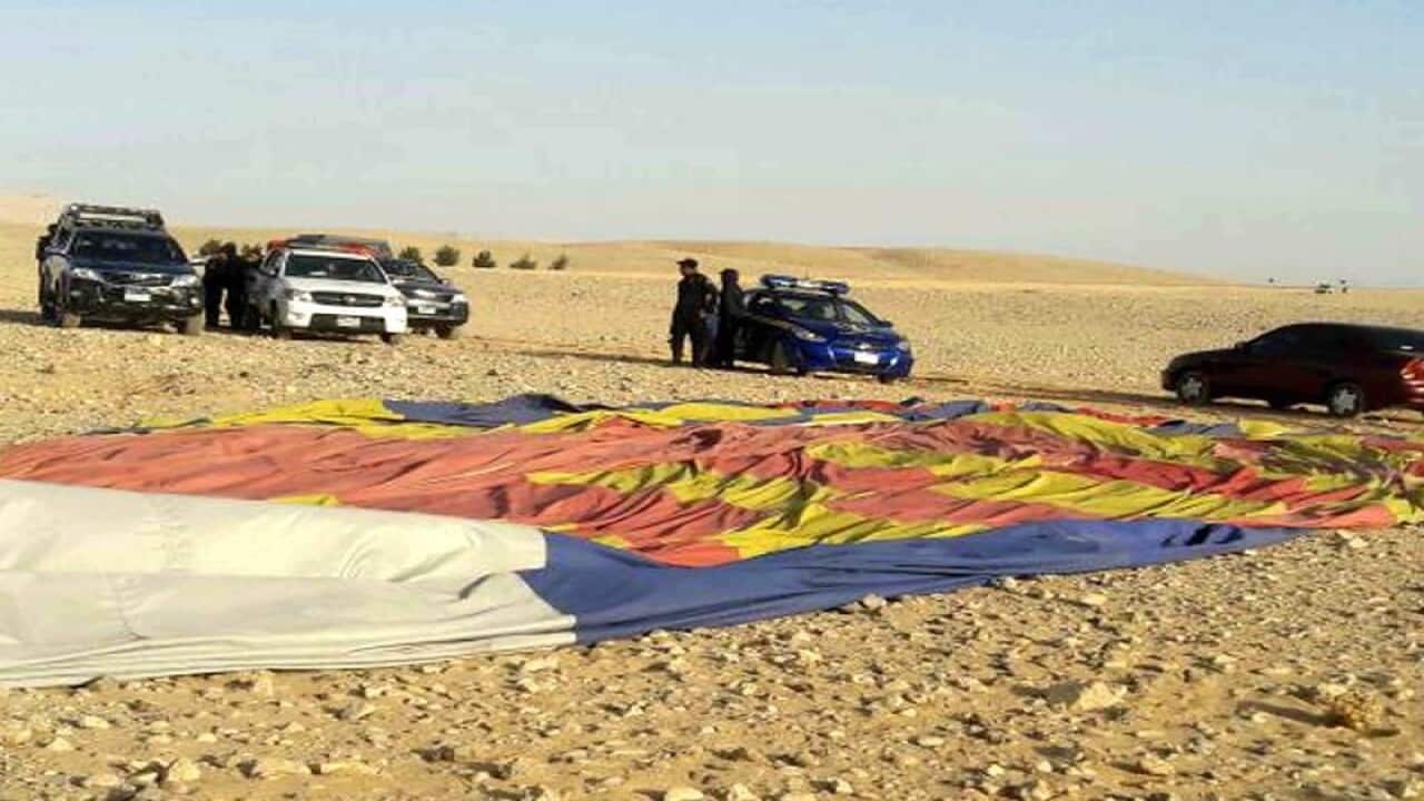 Police officers inspect the site of the hot air balloon crash landing