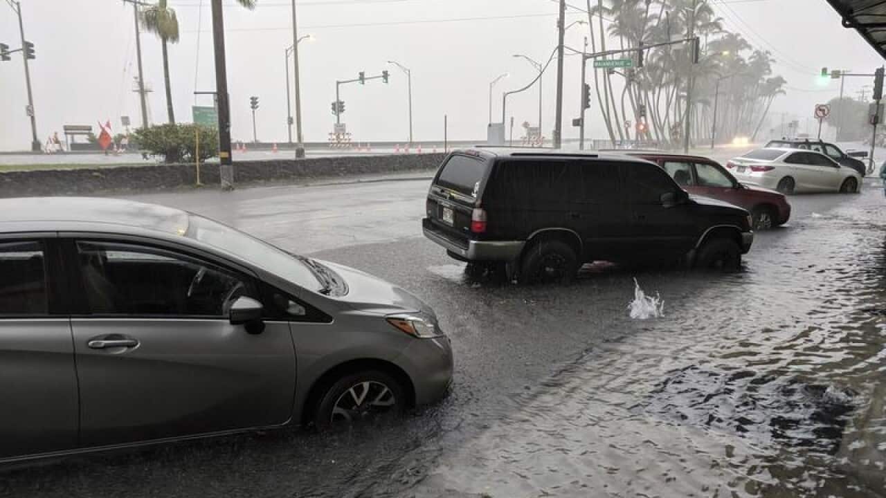 Cars parked in flood waters.
