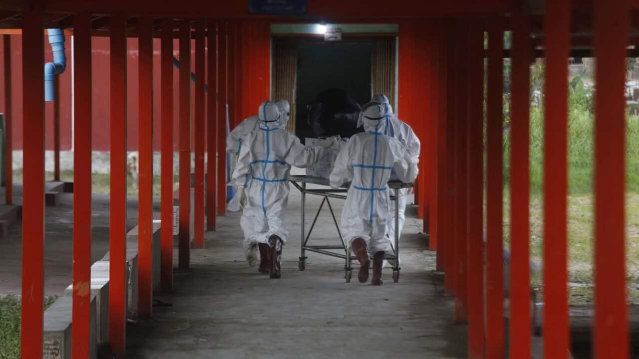 Workers shift a coffin with a COVID-19 victim at the Sittwe Hospital to a cemetery at Sittwe Rakhine, Myanmar, 6 July 2021