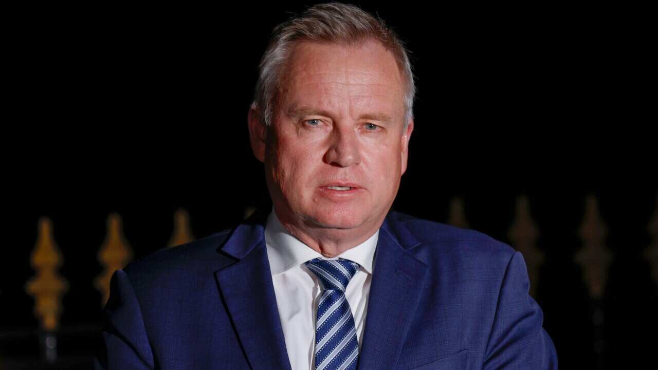 Jeremy Rockliff, wearing a blue suit, speaking at night.
