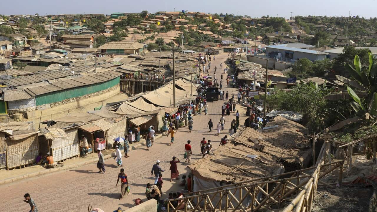 Rohingya refugees walk through one of the arterial roads at the Kutupalong refugee camp in Cox's Bazar, Bangladesh.