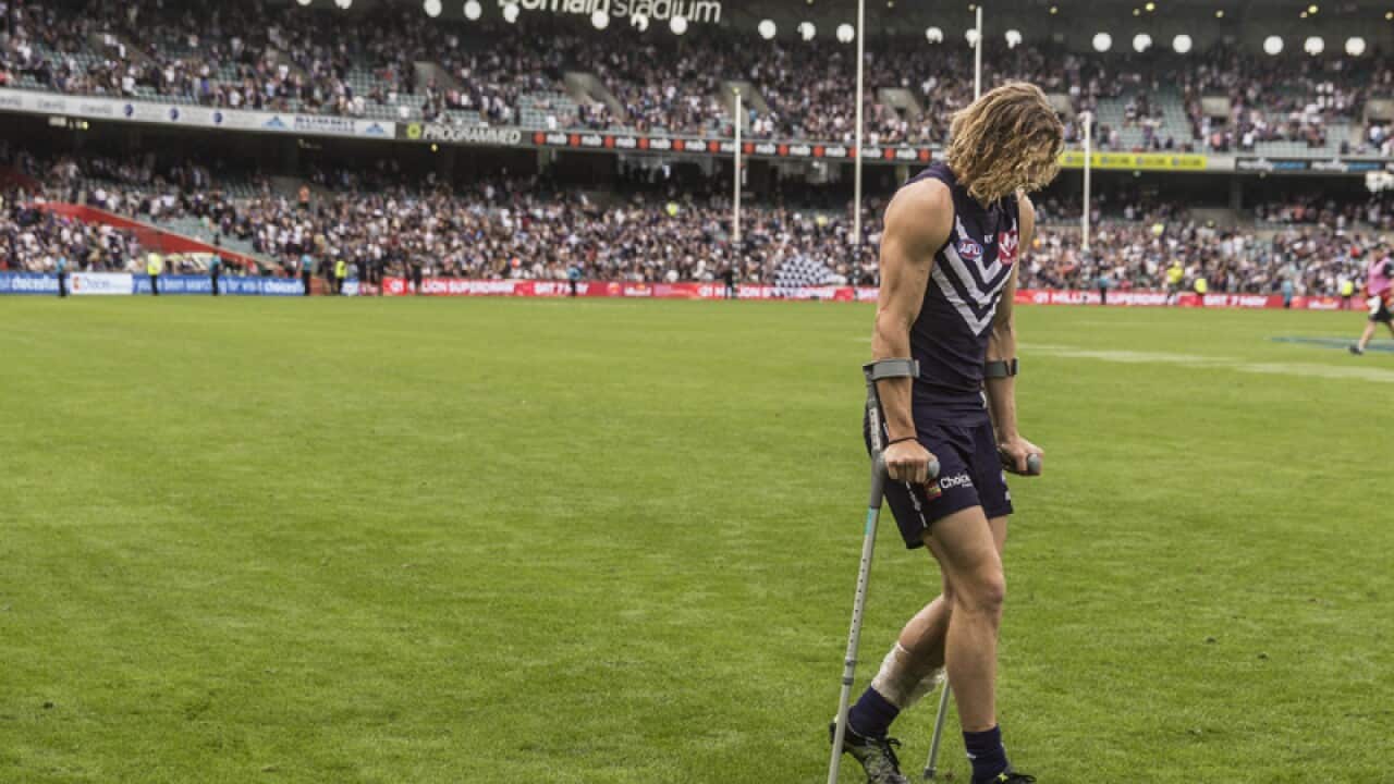 Nat Fyfe of the Fremantle Dockers leaves the ground injured