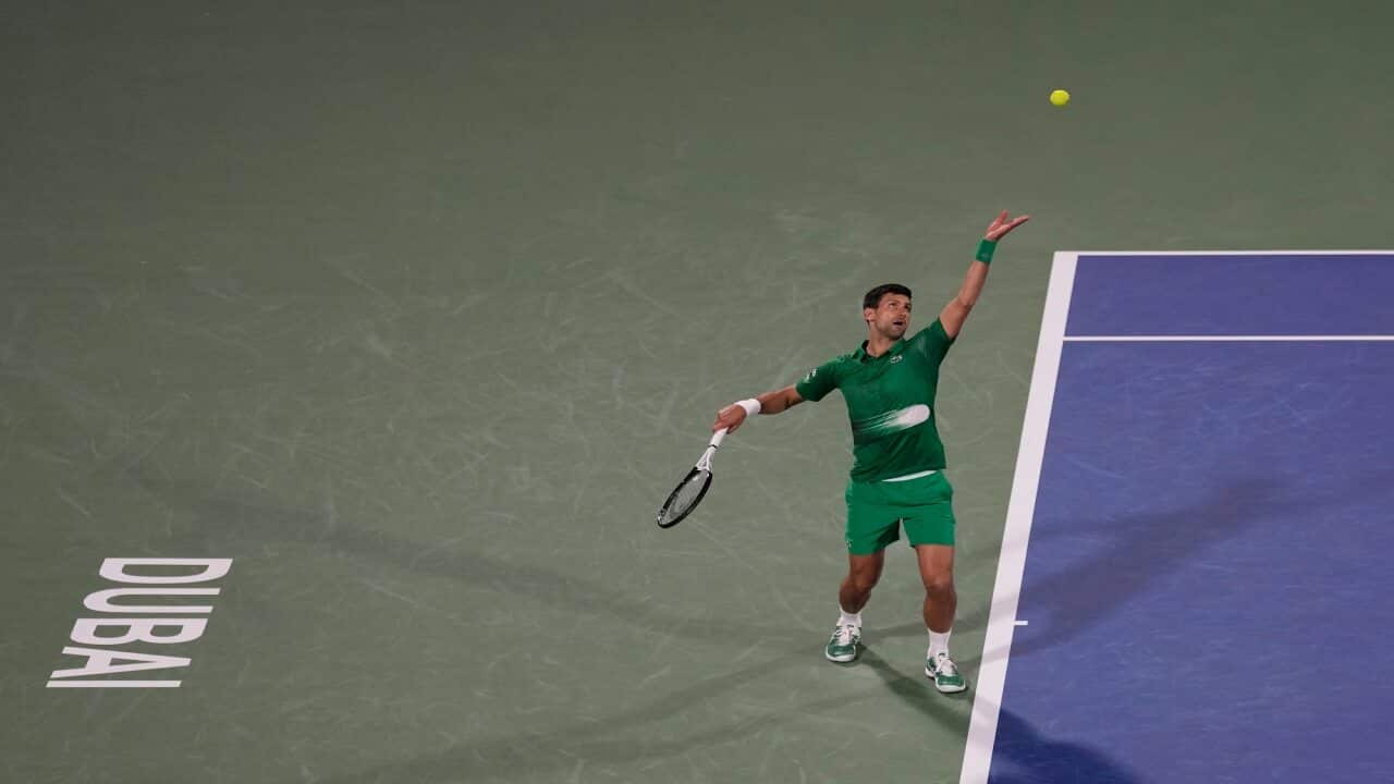 Novak Djokovic serves to Lorenzo Musetti during the Dubai Duty Free Tennis Championship.