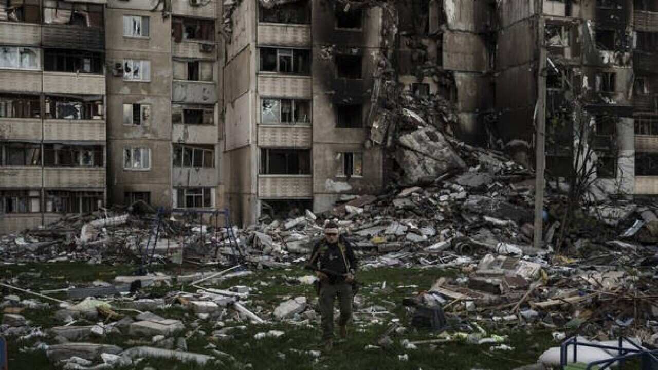 A Ukrainian serviceman walks amid the rubble of a building heavily damaged by multiple Russian bombardments near a frontline in Kharkiv.