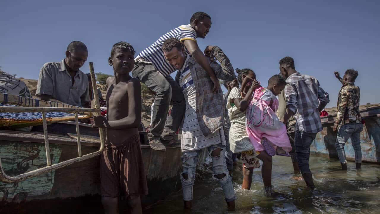 Tigray refugees arrive on the banks of the Tekeze River on the Sudan-Ethiopia border