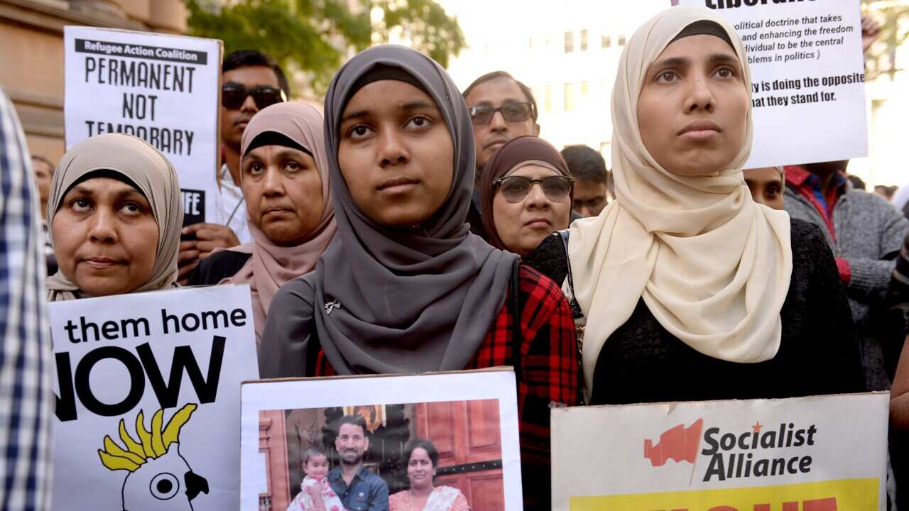 Demonstrators march through Sydney's CBD during a rally calling for refugee rights in Sydney.