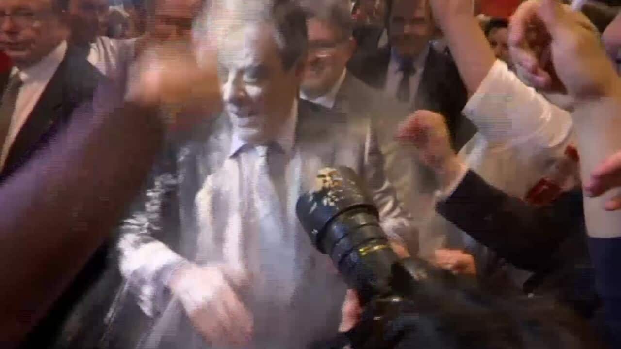 Conservative French presidential candidate Francois Fillon is doused with flour.