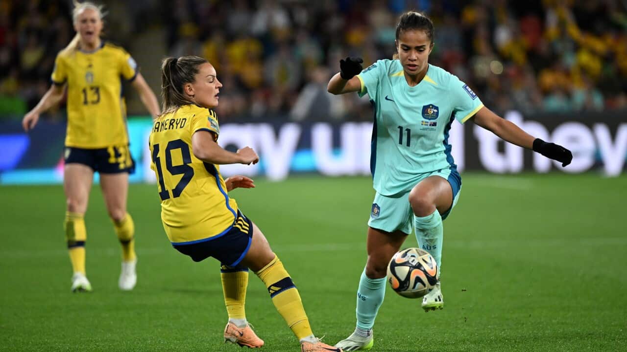 Mary Fowler moves the ball, tussling with Johanna Kaneryd.