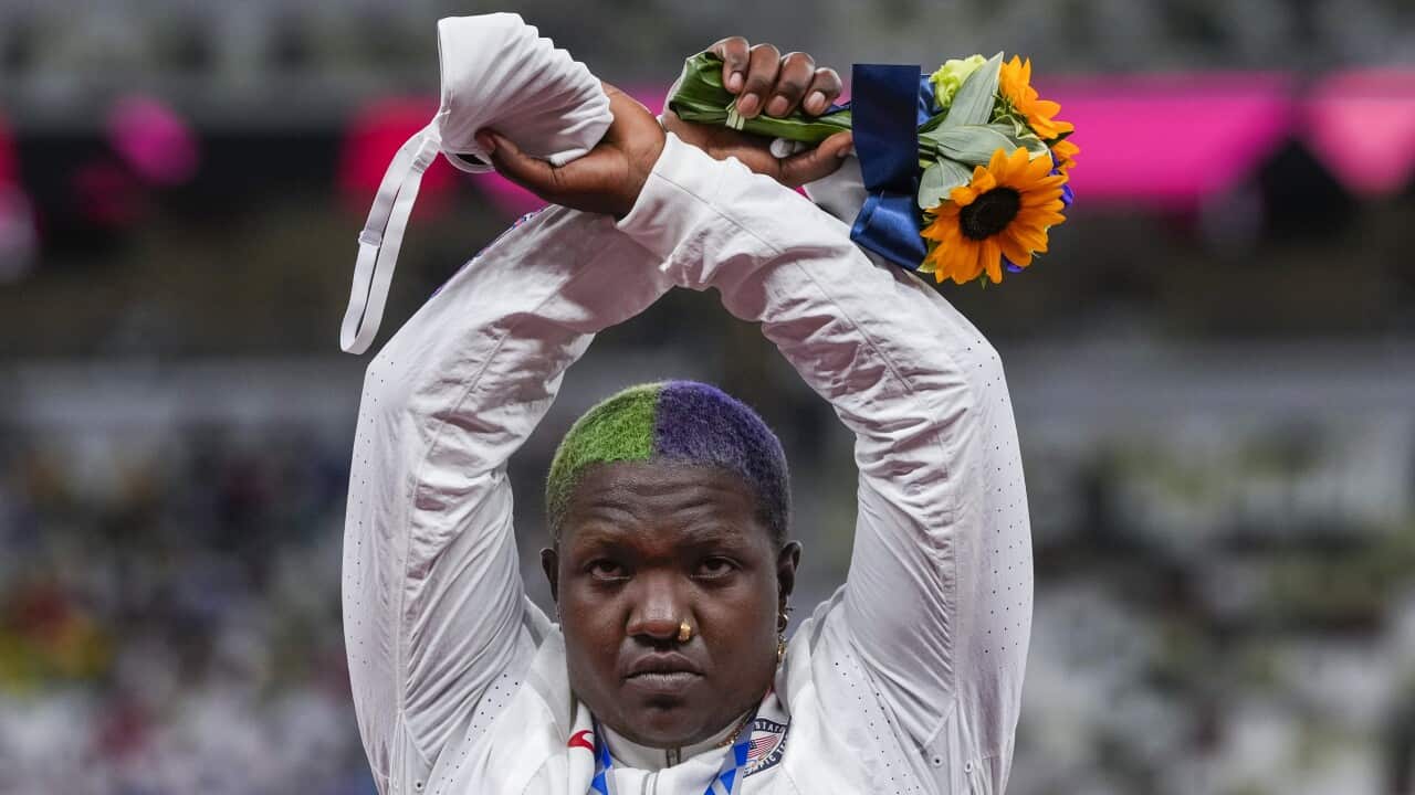 Raven Saunders poses with her silver medal for the women's shot put on the podium