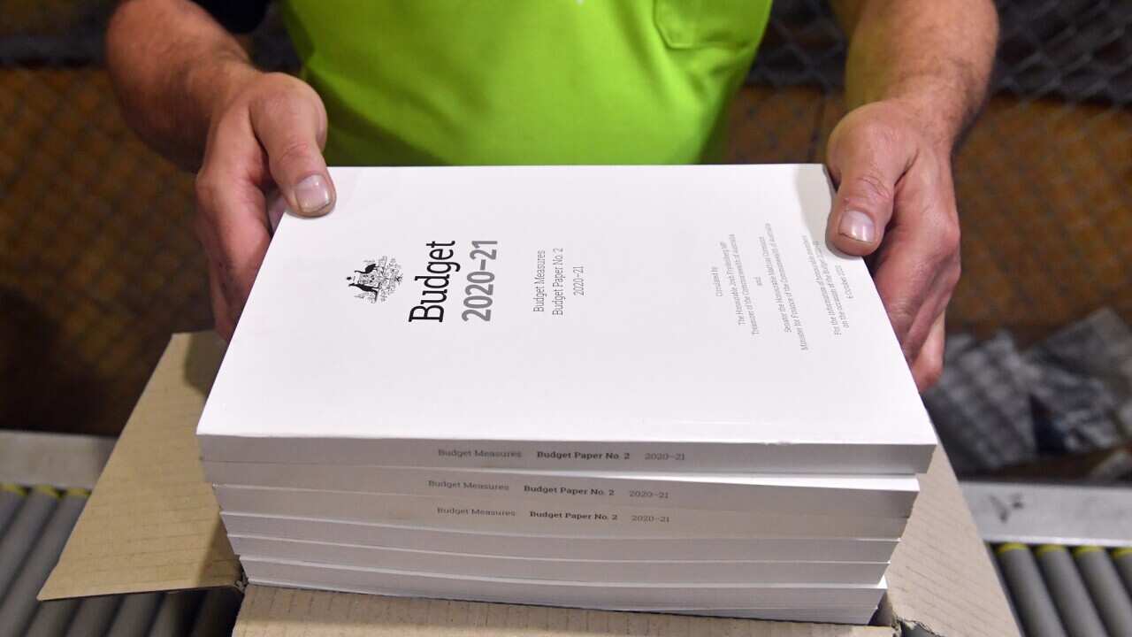 The 2020-2021 Budget Papers are seen at a printing facility prior to being delivered to Parliament House in Canberra, Sunday, October 4, 2020. (AAP Image/Mick Tsikas) NO ARCHIVING