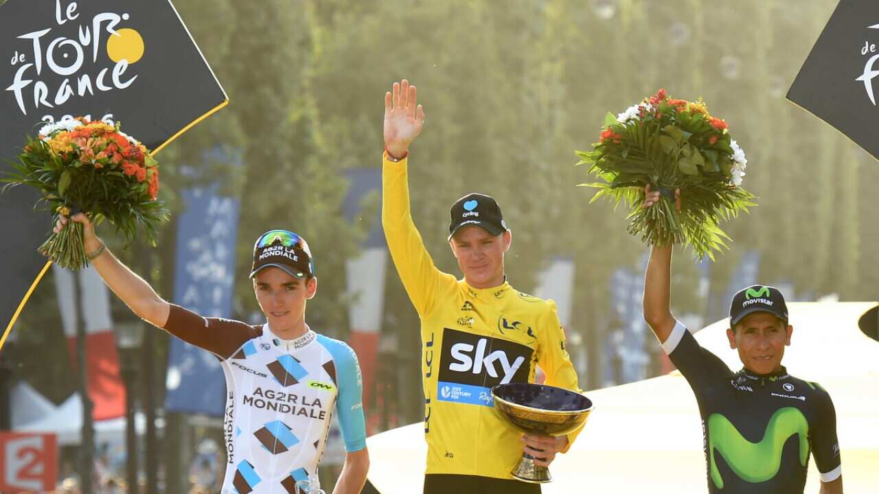 Team Sky's Chris Froome celebrates for winning the Tour De France with second placed Romain Bardet (L) and third-placed Nairo Quintan.