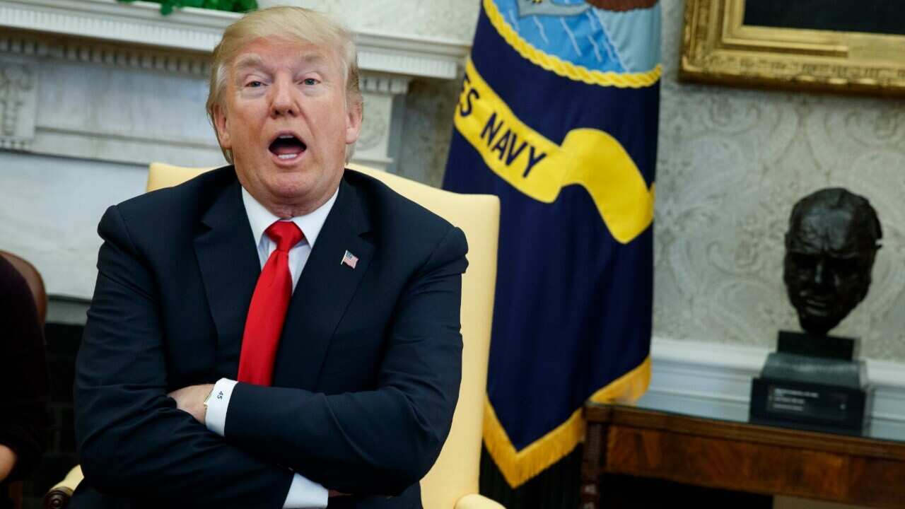 President Donald Trump speaks with reporters about allowing the release of a secret memo on the FBI.'s role in the Russia inquiry
